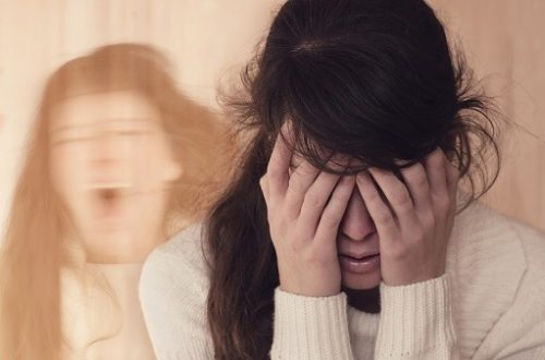 woman overwhelmed by sadness and sorrow brought by bipolar disorder.